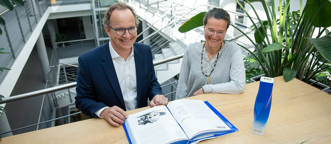 Barbara Austel en Sascha Menges met de trofee van "Merken van de eeuw" en het bijbehorende boek.