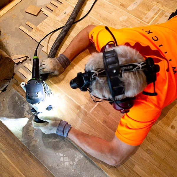 De Finse parketlegger bewerkt de houten vloer met de Festool bovenfrees